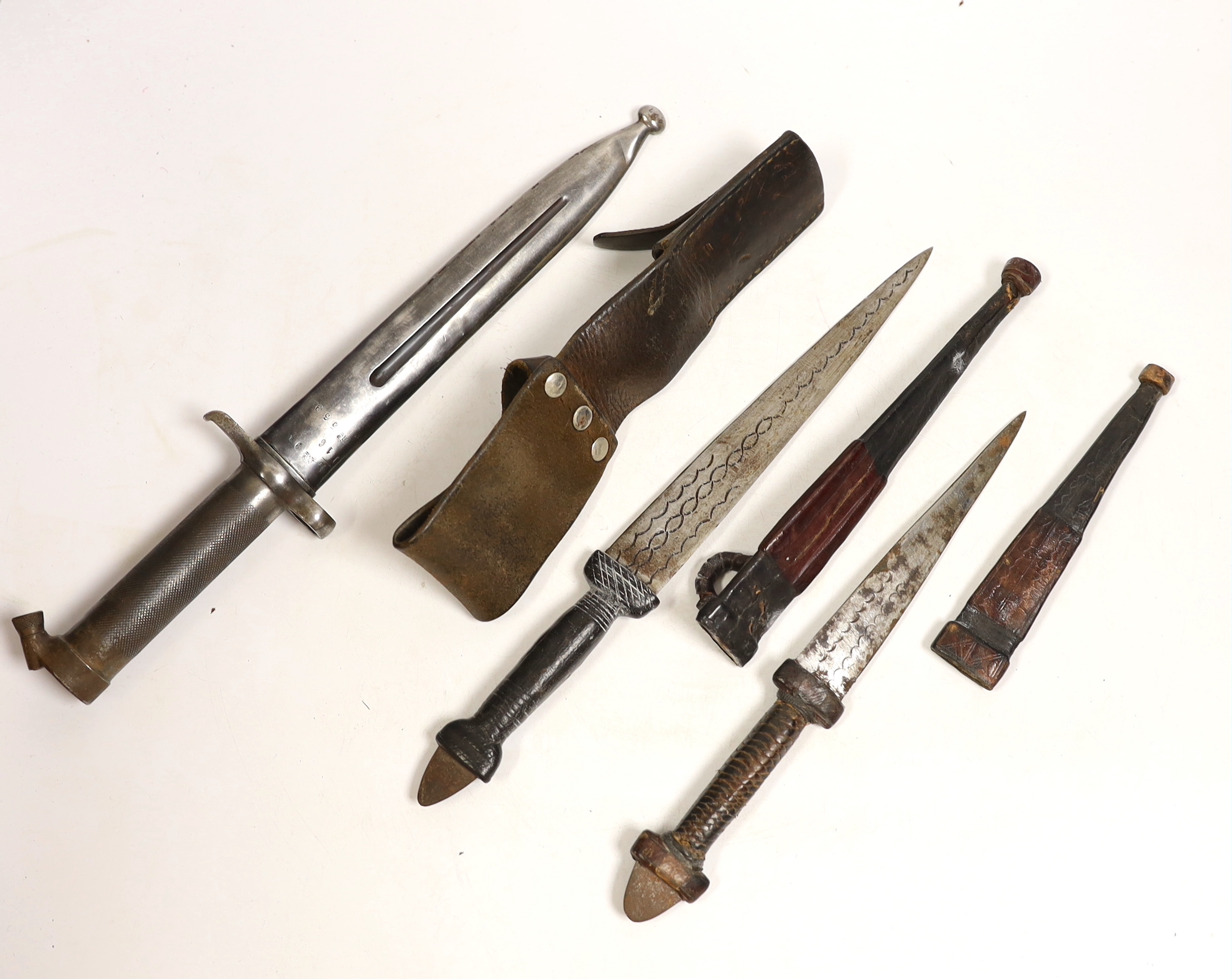 A Swedish Mauser bayonet and two North African daggers